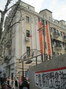 The apartment building where the protestors live, with a glimpse of their banner in the foreground.