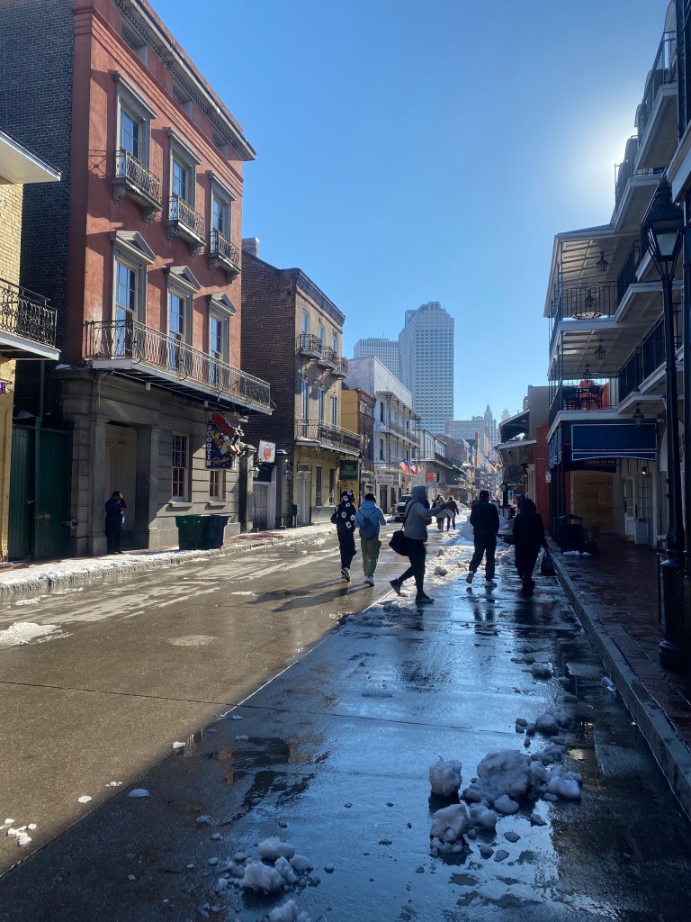 Bourbon Street, now free of ice and with groups of people walking on it.