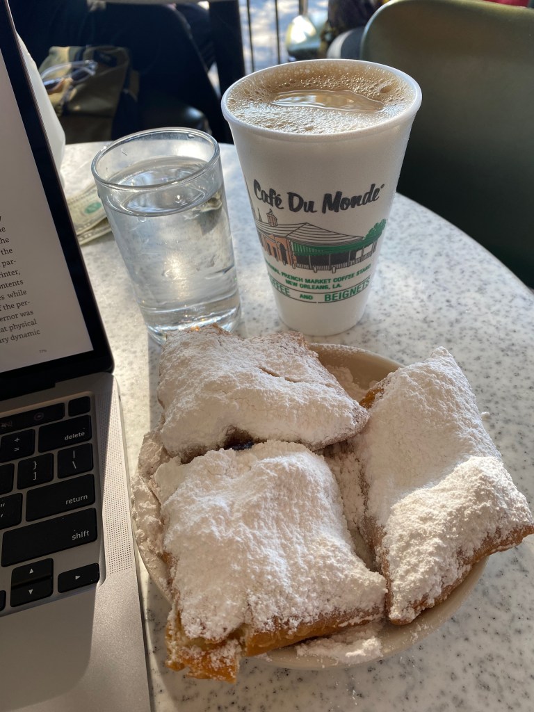 Coffee and beignets, covered with powdered sugar