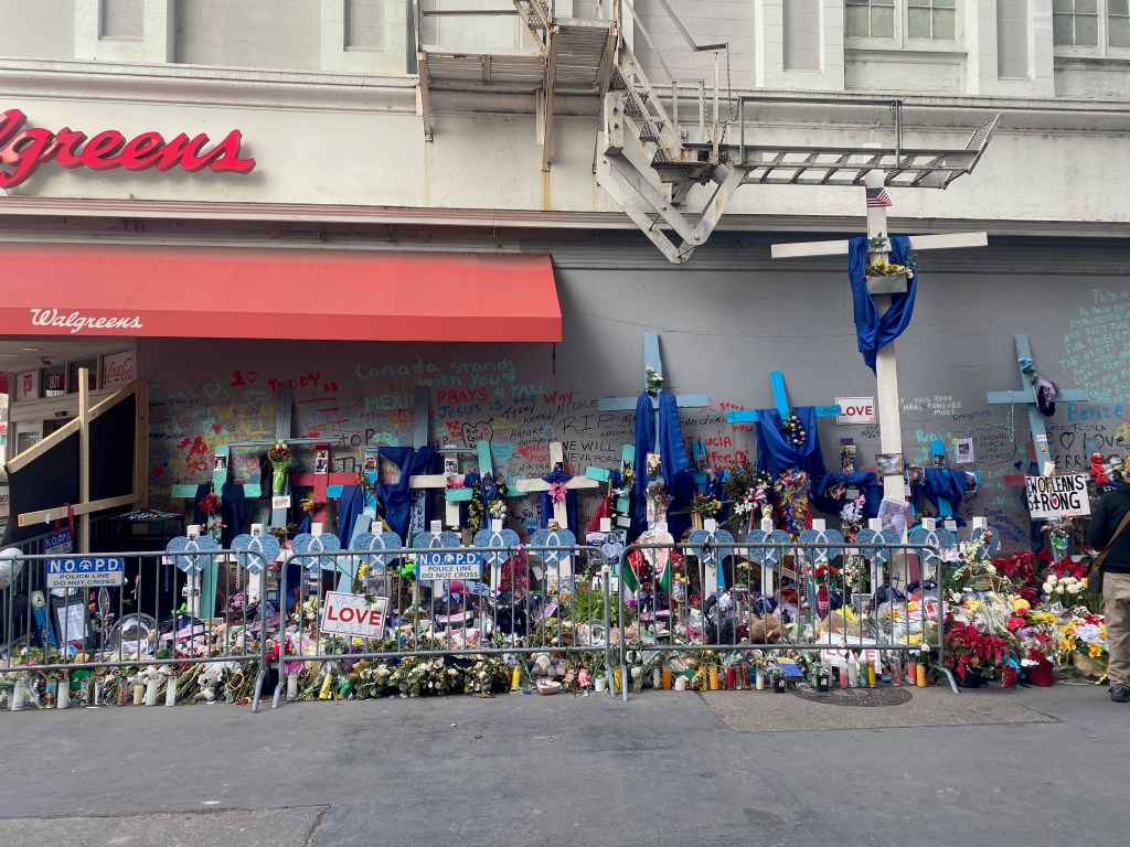 Crosses, flowers, and photographs fill a section of Bourbon Street in a memorial to victims of the attack on New Year's Day 2025.