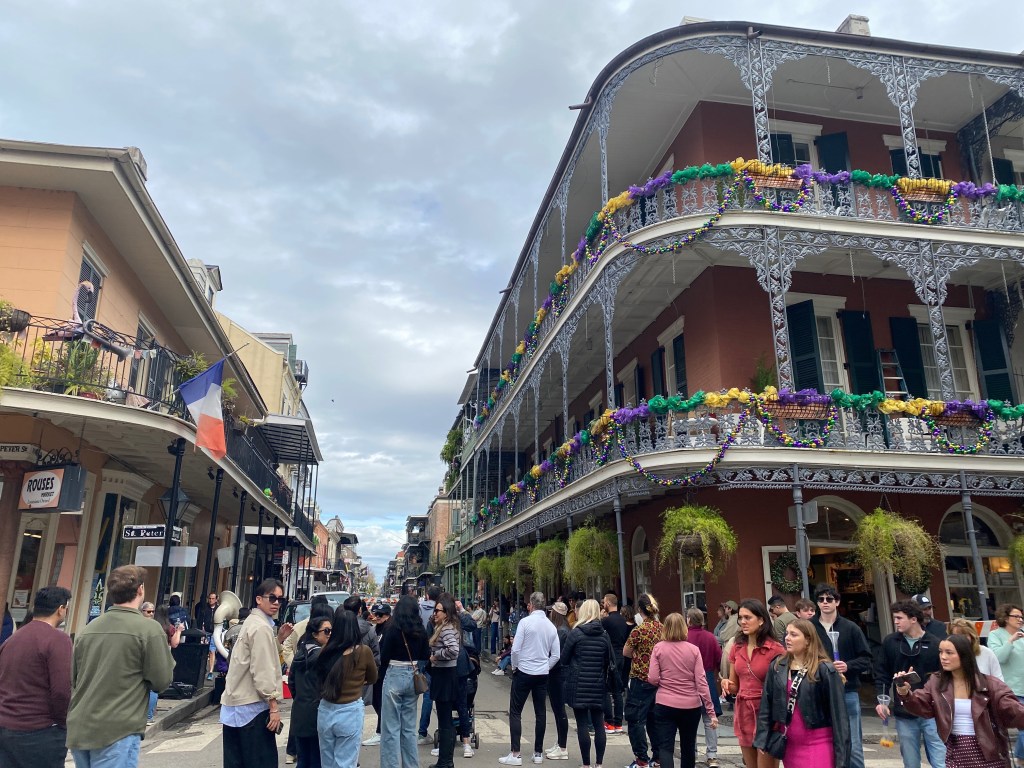 Crowds on a busy street in the French Quarter of New Orleans.