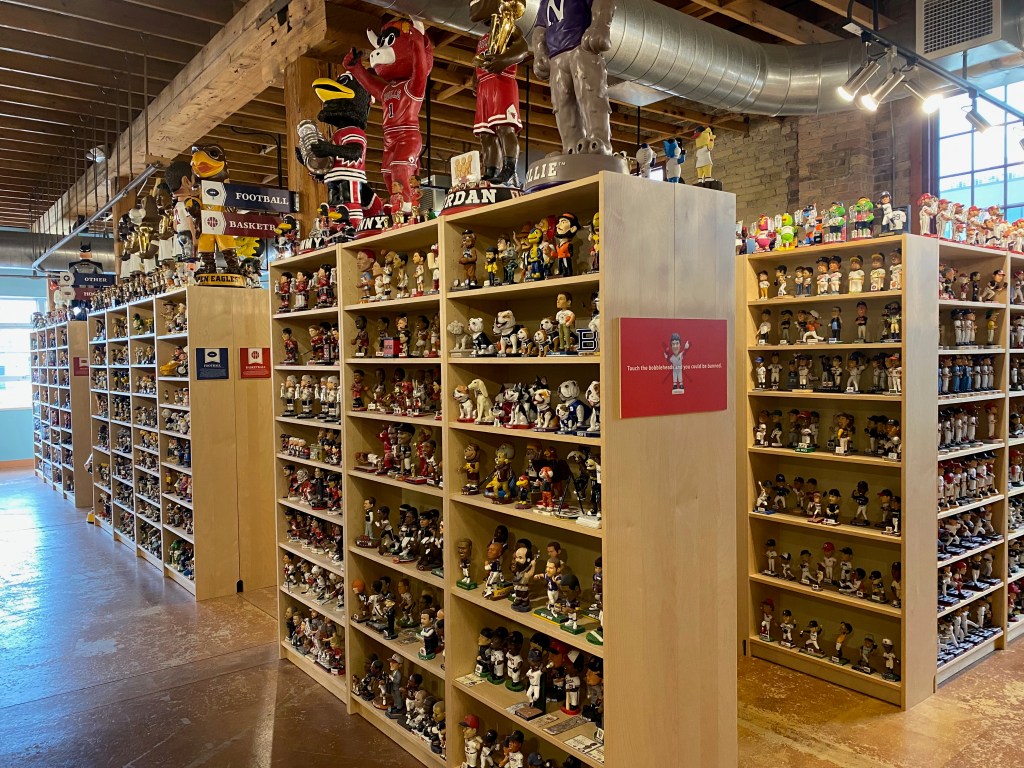 A photograph of many bookshelves, filled to capacity with bobblehead figurines.