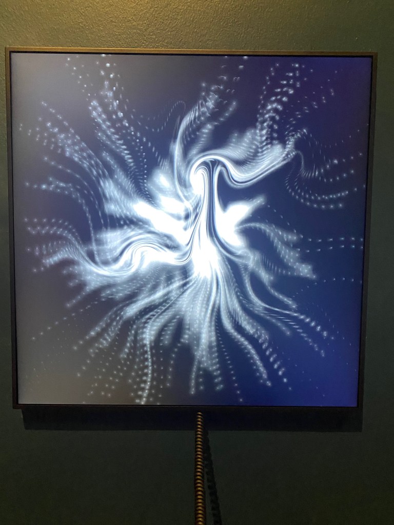 While lines trace designs against a black screen.