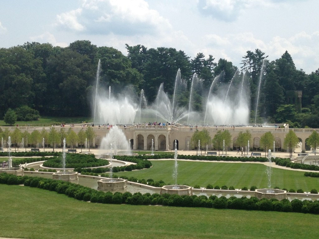 Fountains set in a manicured garden spray water in various directions