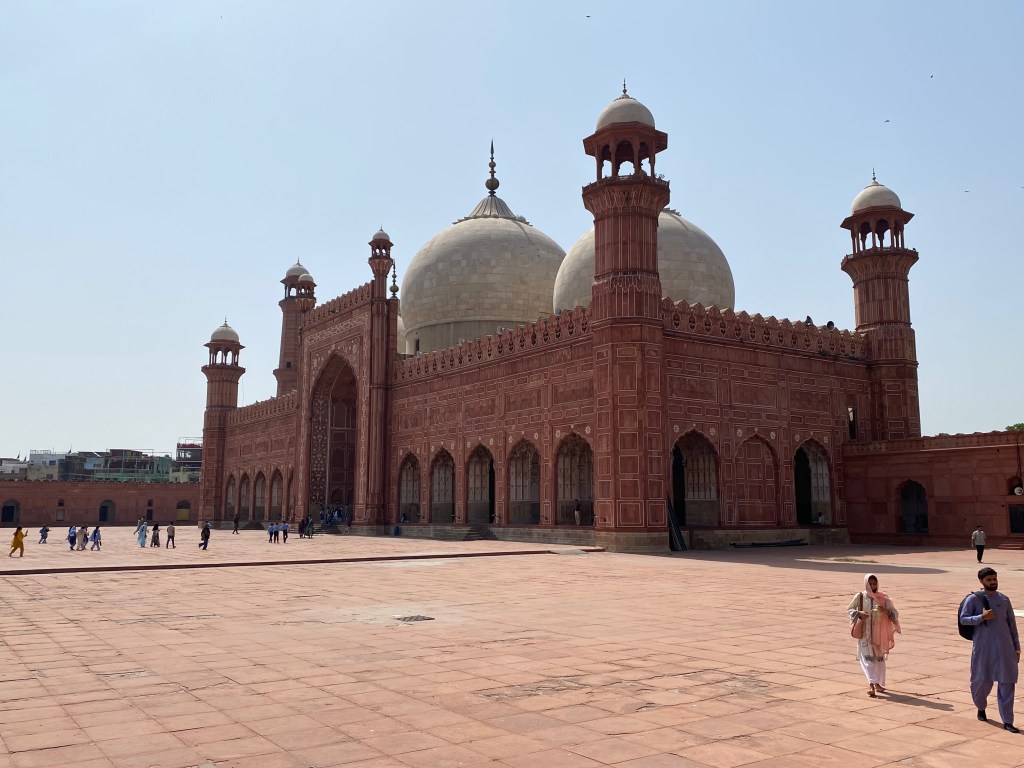 Photograph of a large red sandstone mosque
